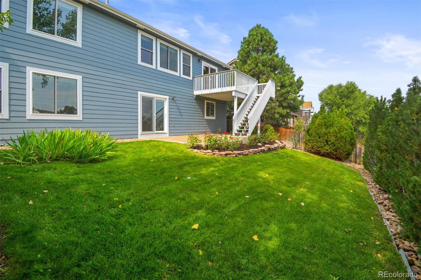 10230 Rustic Redwood Way Highlands Ranch, CO 80126 - Photo 43 of 50 a front view of a house with a yard