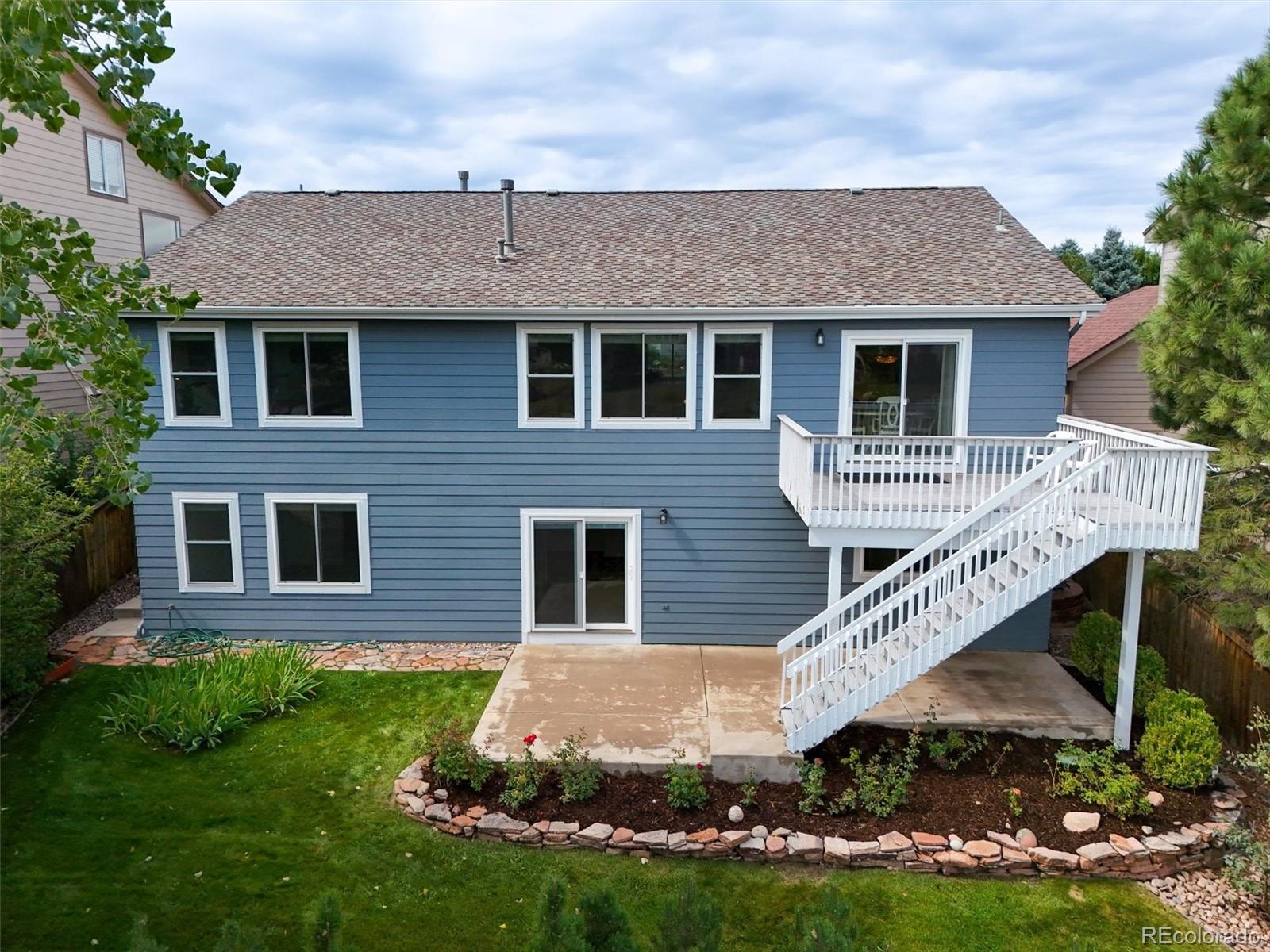 10230 Rustic Redwood Way Highlands Ranch, CO 80126 - Photo 44 of 50 a front view of a house with garden