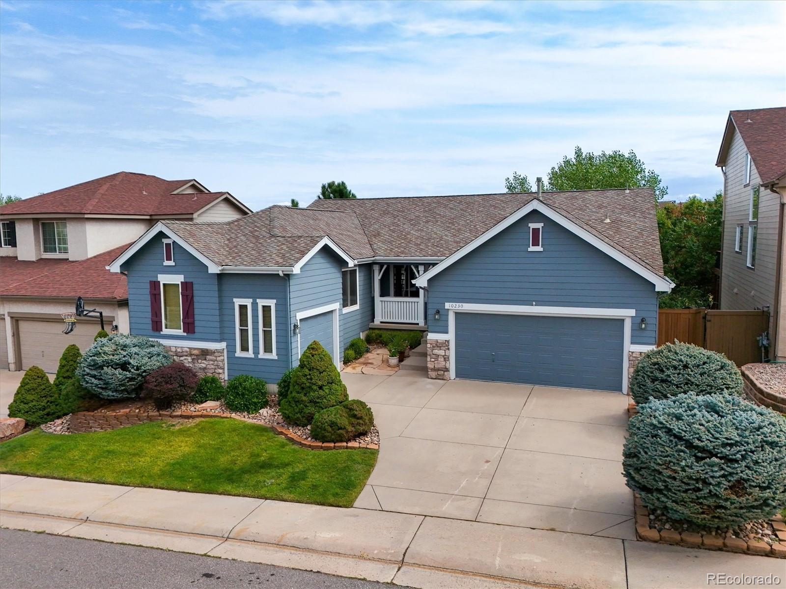 10230 Rustic Redwood Way Highlands Ranch, CO 80126 - Photo 46 of 50 a front view of a house with a yard and garage