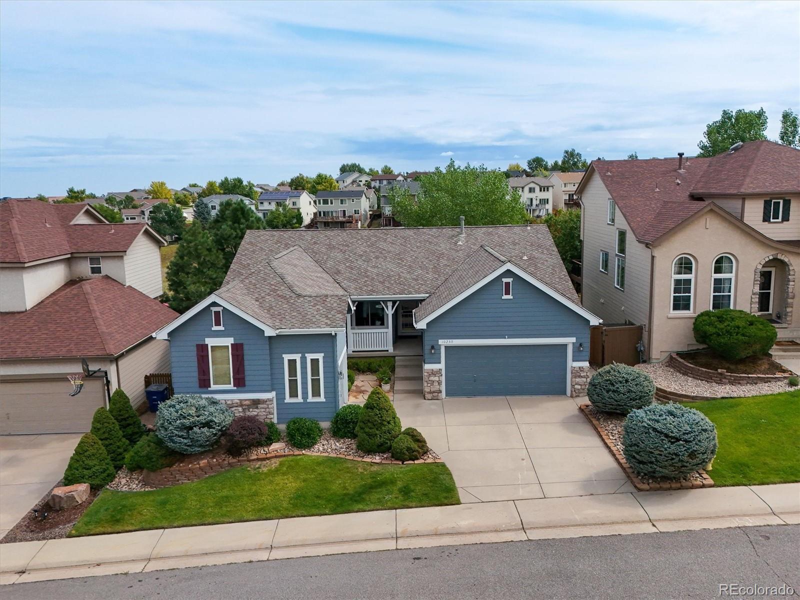 10230 Rustic Redwood Way Highlands Ranch, CO 80126 - Photo 47 of 50 front view of a house with a yard