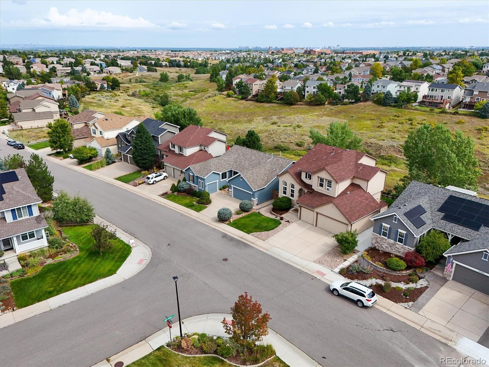 10230 Rustic Redwood Way Highlands Ranch, CO 80126 - Photo 49 of 50 an aerial view of a house with a garden and lake view