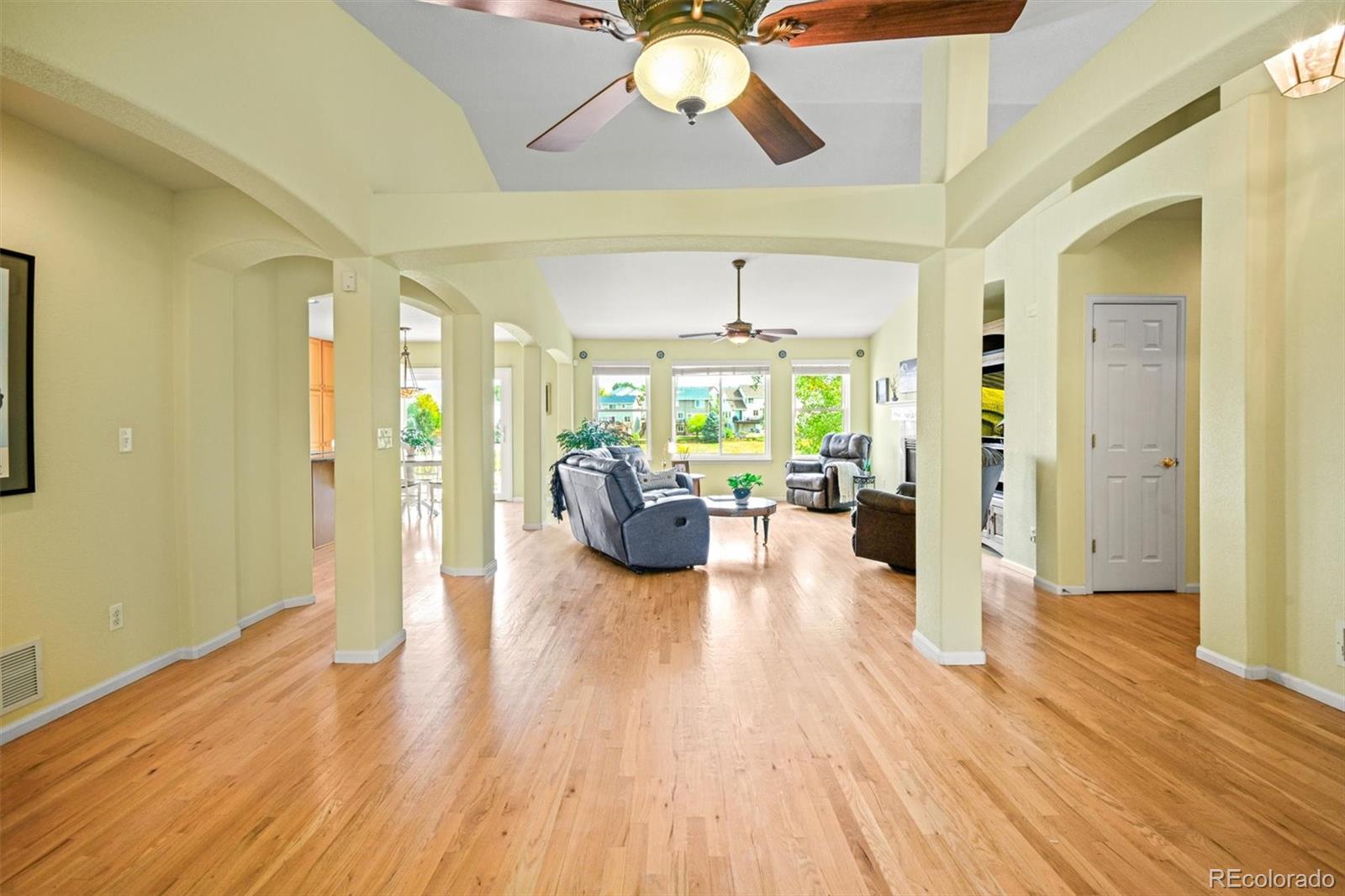 10230 Rustic Redwood Way Highlands Ranch, CO 80126 - Photo 6 of 50 a living room with furniture and a chandelier