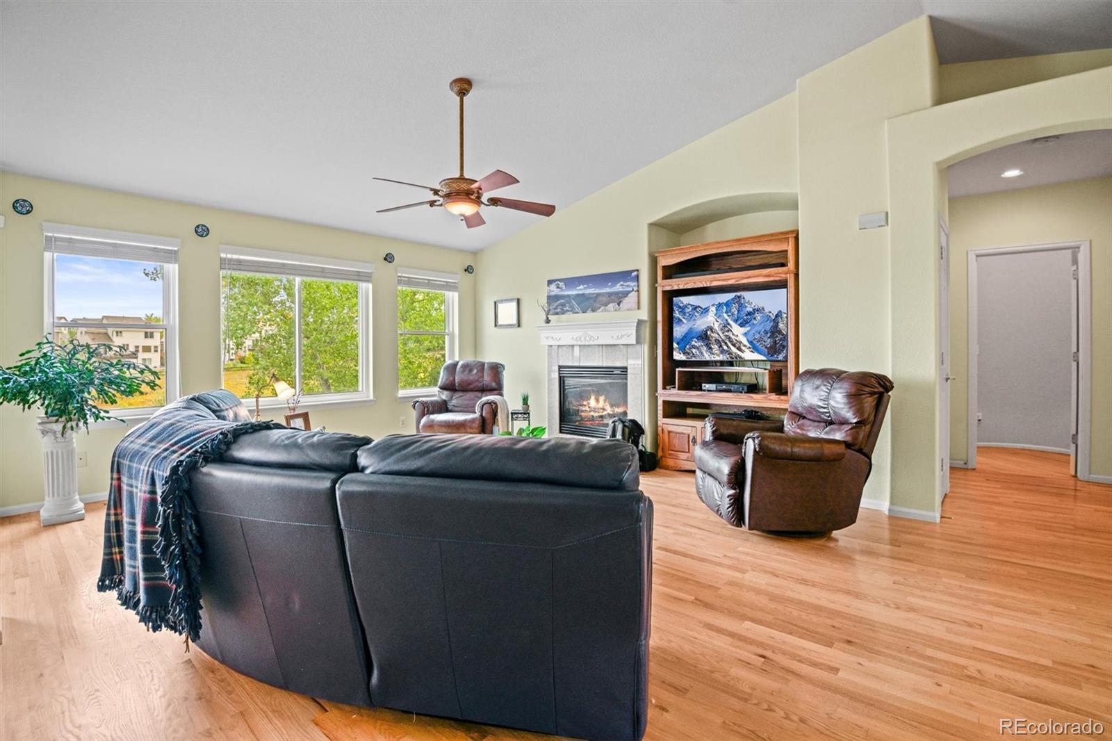10230 Rustic Redwood Way Highlands Ranch, CO 80126 - Photo 8 of 50 a living room with furniture and a flat screen tv