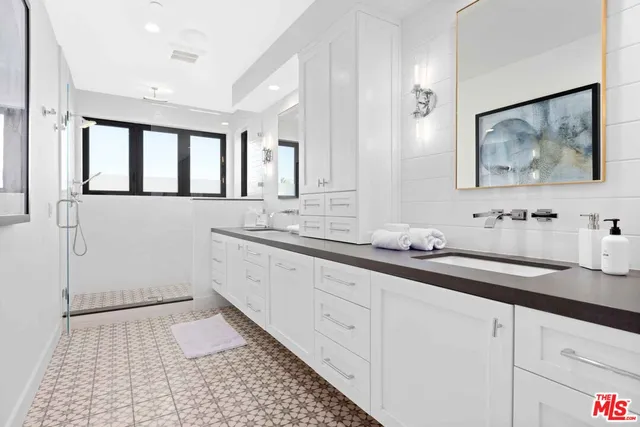 a bathroom with a sink a mirror and a toilet