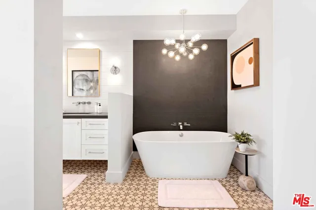 a bathroom with a bathtub a sink and a mirror