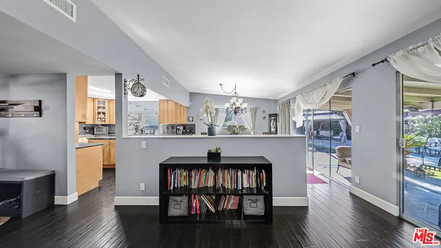 a living room with wooden floor and furniture