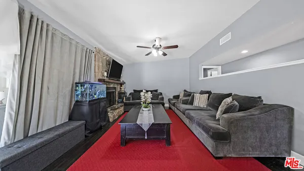 a living room with furniture and a fireplace