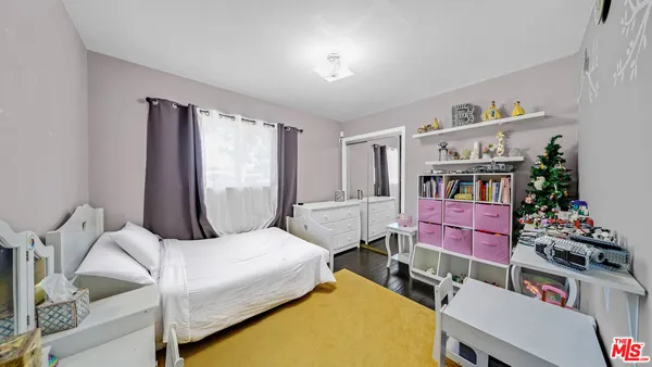 a bedroom with a bed and a bookshelf
