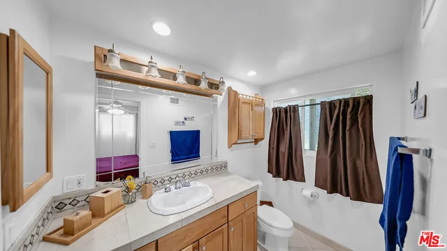 a bathroom with a sink vanity granite and a mirror