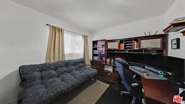 a living room with furniture a flat screen tv and a window
