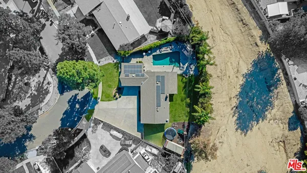 an aerial view of a house with a yard