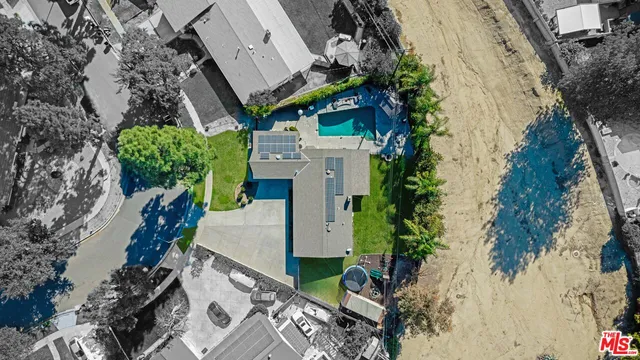 an aerial view of a house with a yard
