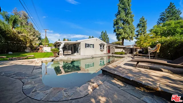 a view of a house with pool porch and sitting area