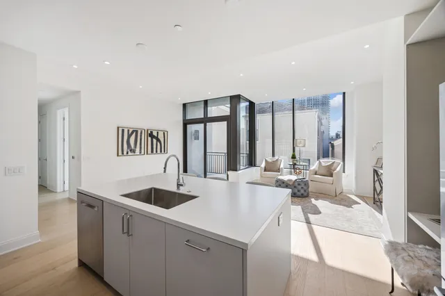 a view of living room with furniture and large windows