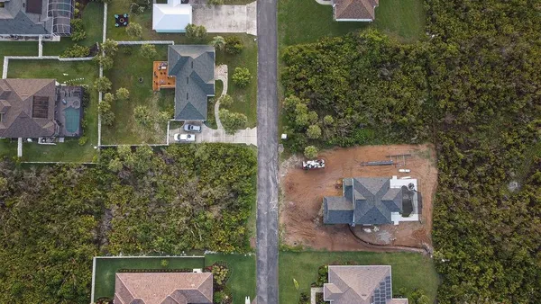 an aerial view of residential house with outdoor space and parking