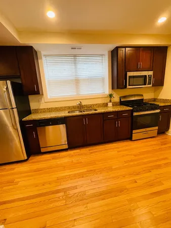 a view of kitchen with sink and microwave