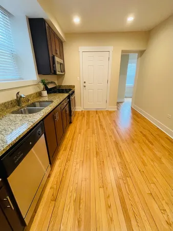 a bathroom with a sink and a wooden floor