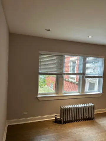 a view of a livingroom with an empty space and a window