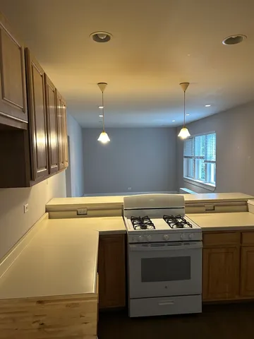 a stove top oven sitting inside of a kitchen