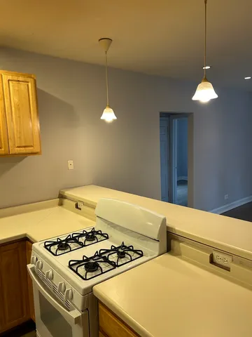 a kitchen with stove and cabinets