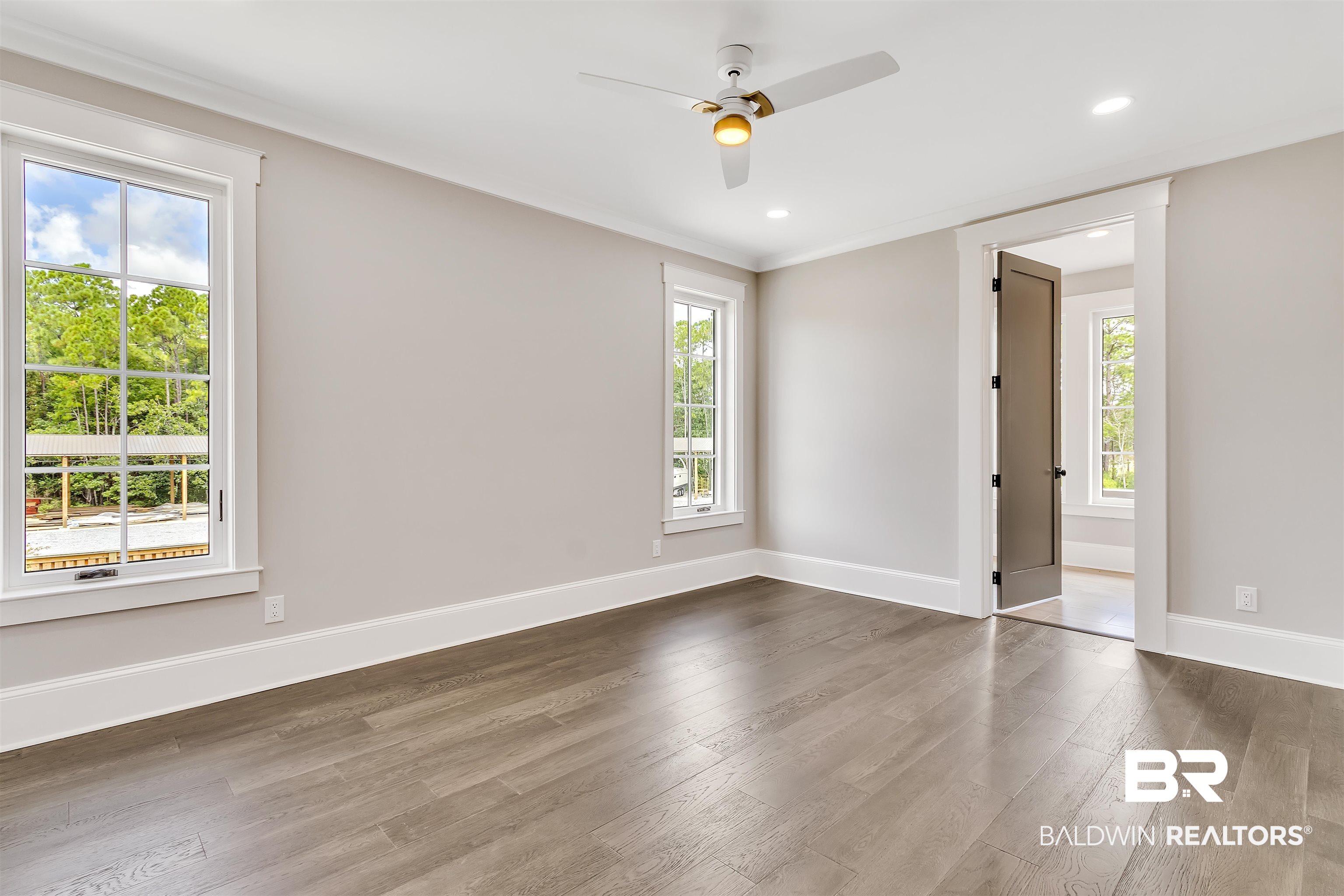 829 Inlet Circle Gulf Shores, AL 36542 - Photo 17 of 31 Unfurnished room with ceiling fan, dark hardwood / wood-style flooring, and crown molding