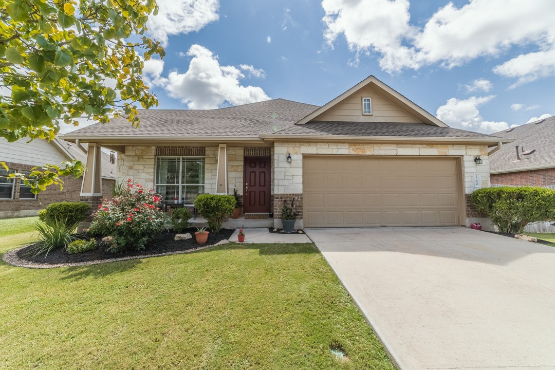 1250 Talley Loop Buda, TX 78610 - Photo 1 of 1 a front view of a house with a garden and plants