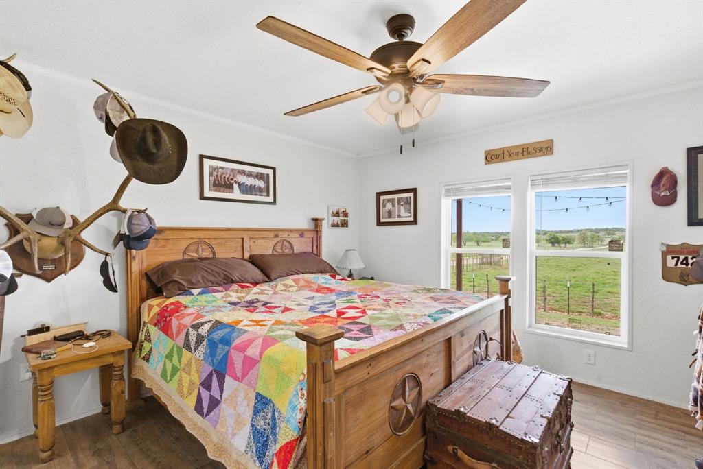 8315 County Road 403 Cisco, TX 76437 - Photo 12 of 40 a bedroom with a bed and a chandelier