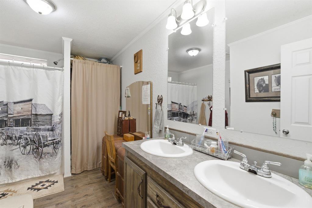 8315 County Road 403 Cisco, TX 76437 - Photo 13 of 40 a bathroom with a sink vanity granite tub and shower