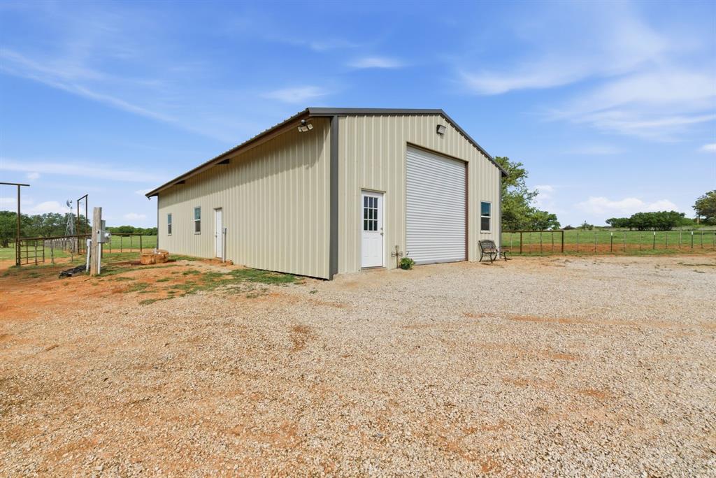 8315 County Road 403 Cisco, TX 76437 - Photo 18 of 40 a view of a house with backyard and bushes