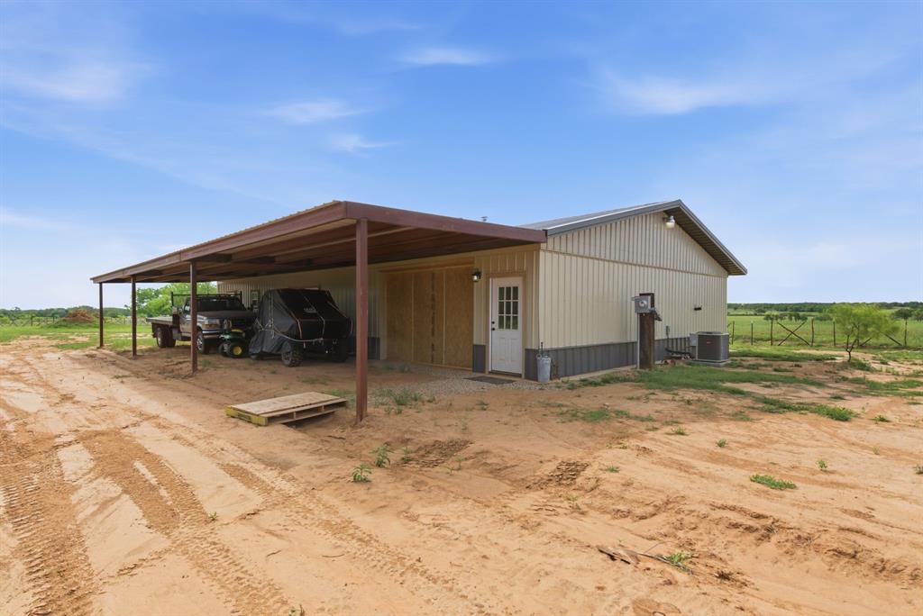 8315 County Road 403 Cisco, TX 76437 - Photo 24 of 40 a view of house with backyard and trees in the background