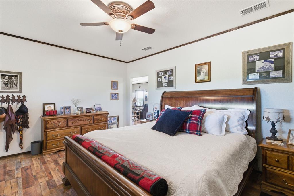8315 County Road 403 Cisco, TX 76437 - Photo 31 of 40 a bedroom with a bed and a chandelier