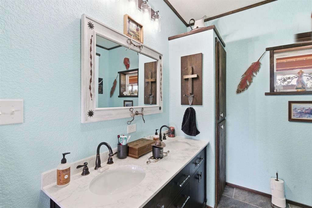 8315 County Road 403 Cisco, TX 76437 - Photo 32 of 40 a bathroom with a sink and a mirror