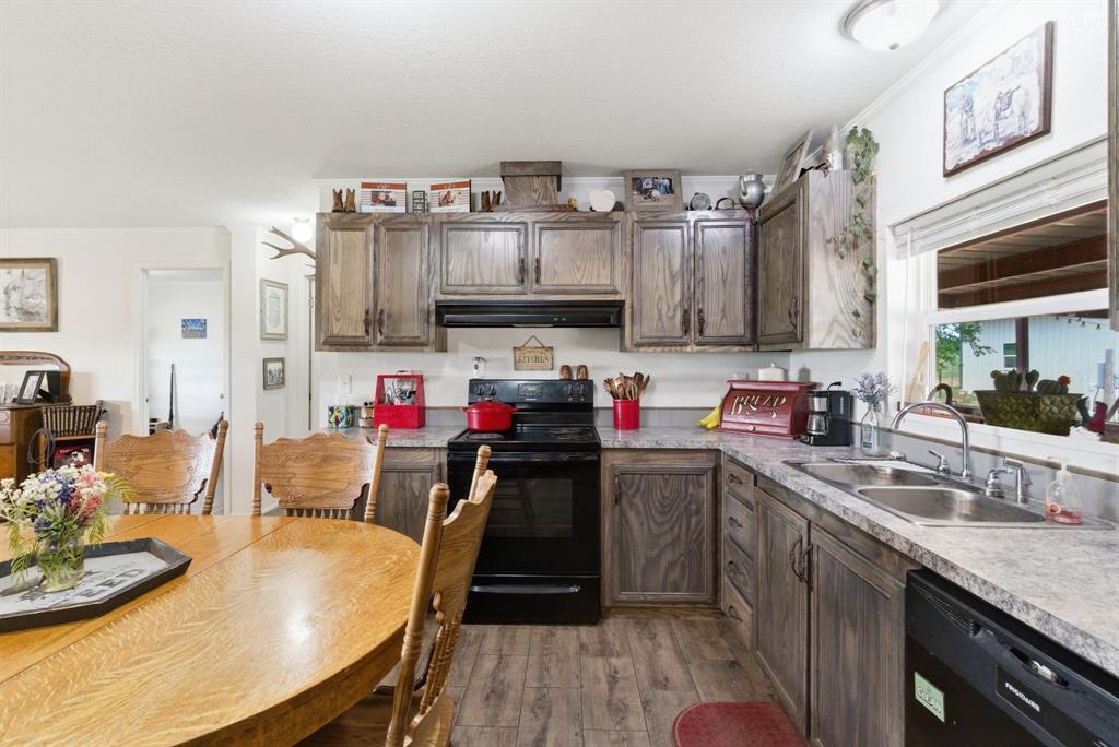 8315 County Road 403 Cisco, TX 76437 - Photo 9 of 40 a kitchen with a table chairs stove and cabinets