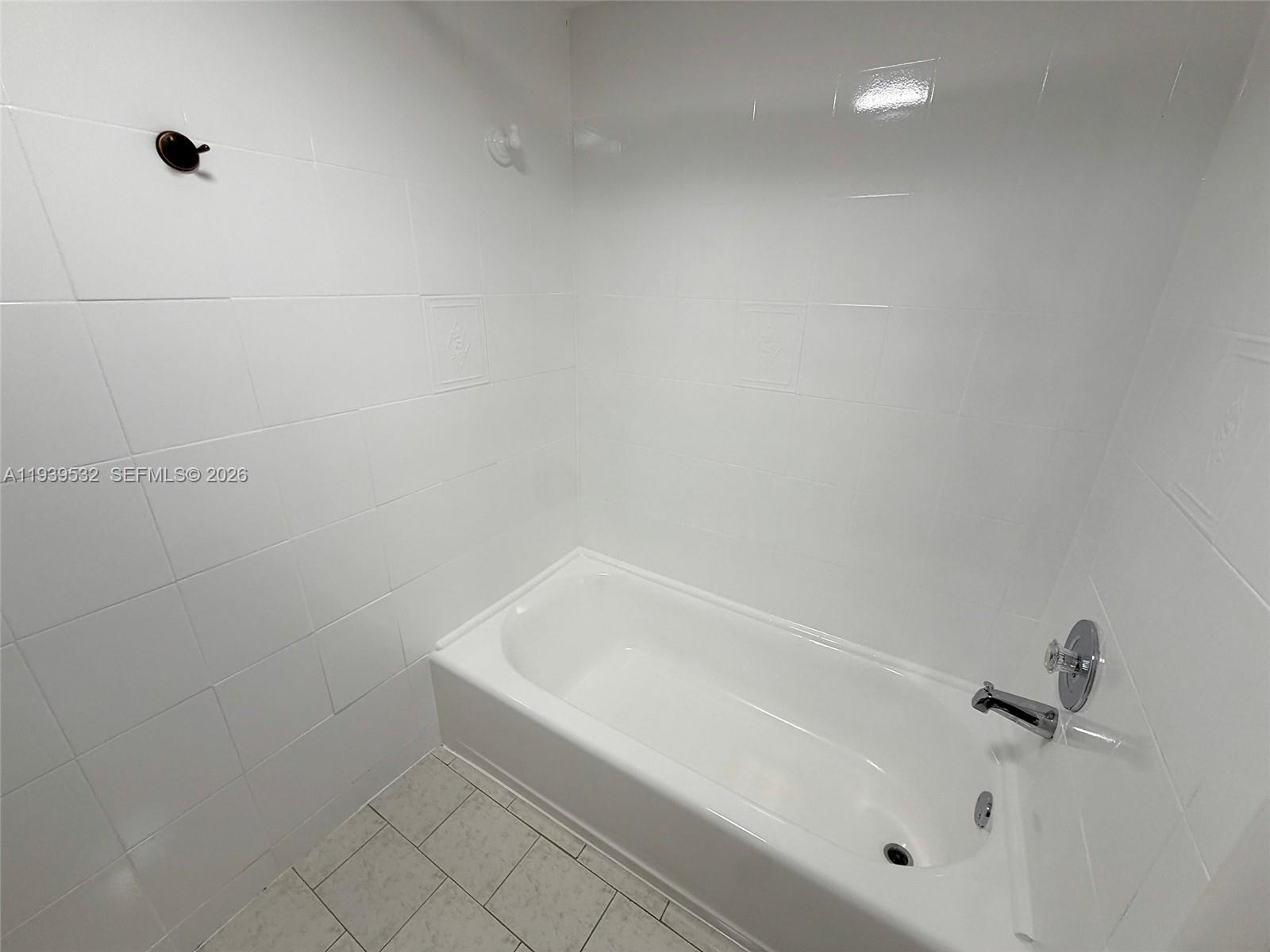 11755 Southwest 18th Street, Unit 109 Miami, FL 33175 - Photo 11 of 21 a bathroom with a bathtub
