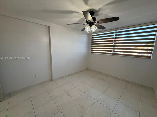 a view of an empty room and a ceiling fan