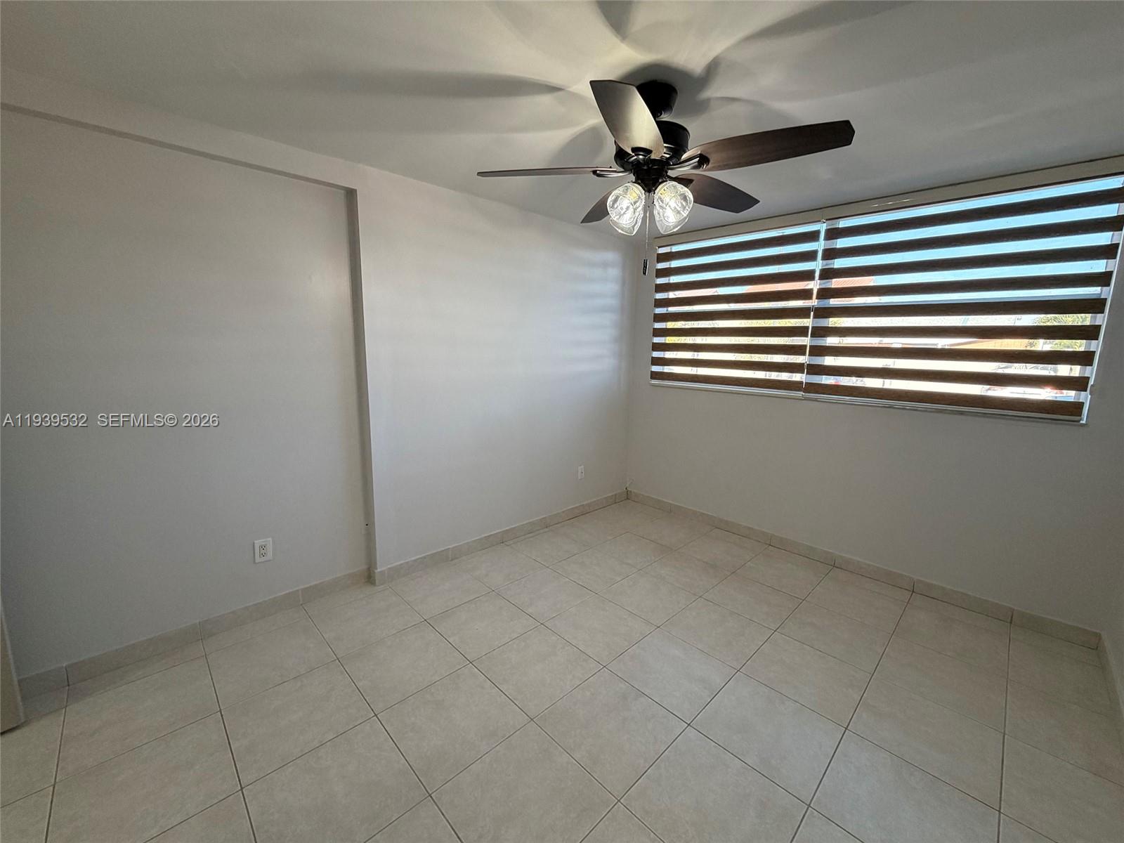 11755 Southwest 18th Street, Unit 109 Miami, FL 33175 - Photo 14 of 21 a view of an empty room and a ceiling fan