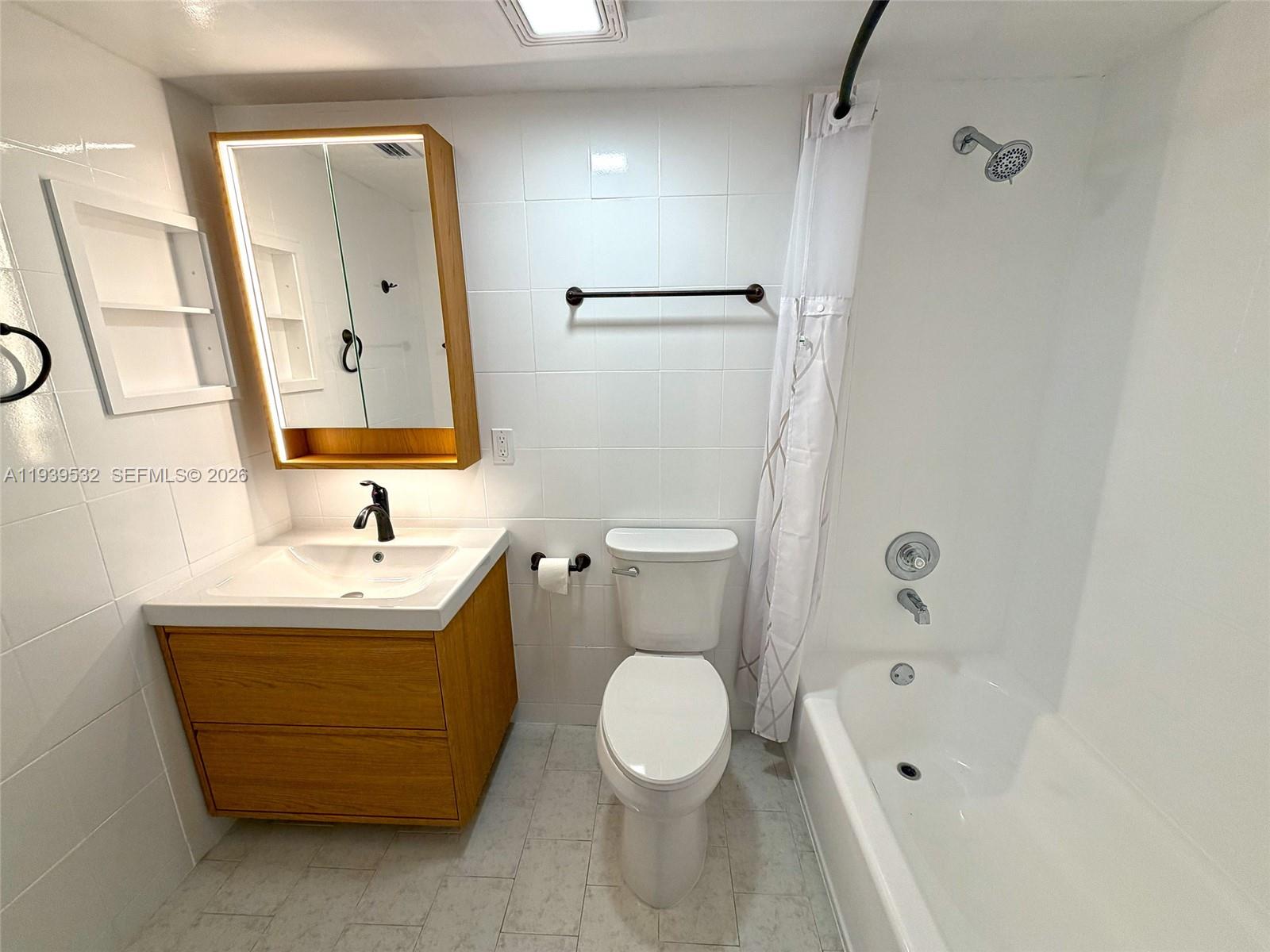 11755 Southwest 18th Street, Unit 109 Miami, FL 33175 - Photo 16 of 21 a bathroom with a sink a toilet and shower