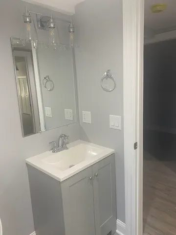 a bathroom with a sink vanity and a mirror