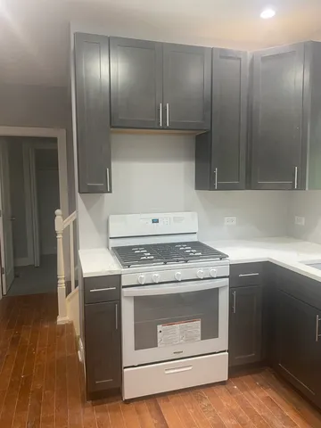 a stove top oven sitting inside of a kitchen