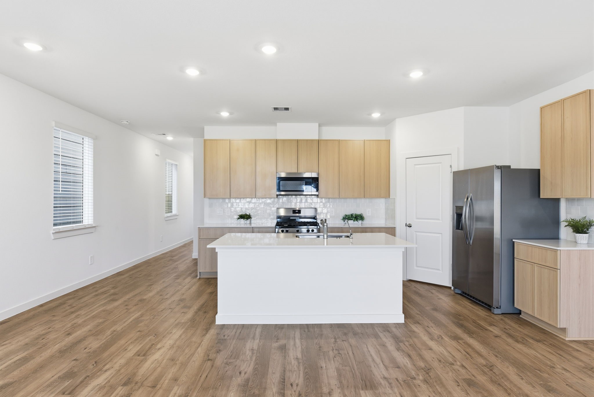 3534 Blue Mockingbird Street Katy, TX 77494 - Photo 6 of 39 The home offers a spacious and practical kitchen which includes SS appliances, quartz countertops, kitchen island, breakfast bar, plenty of storage and countertop space.