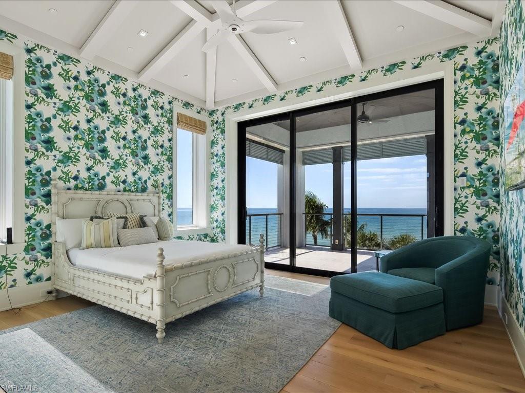 7409 Bay Colony Drive Naples, FL 34108 - Photo 19 of 48 a bedroom with a bed couch and table