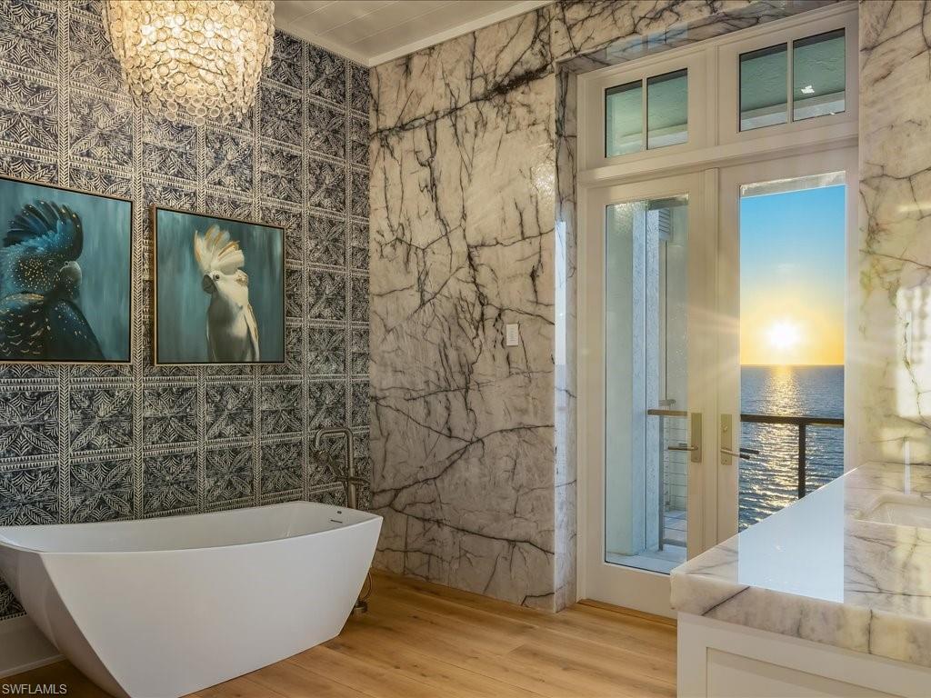 7409 Bay Colony Drive Naples, FL 34108 - Photo 24 of 48 a bathroom with a bathtub and shower