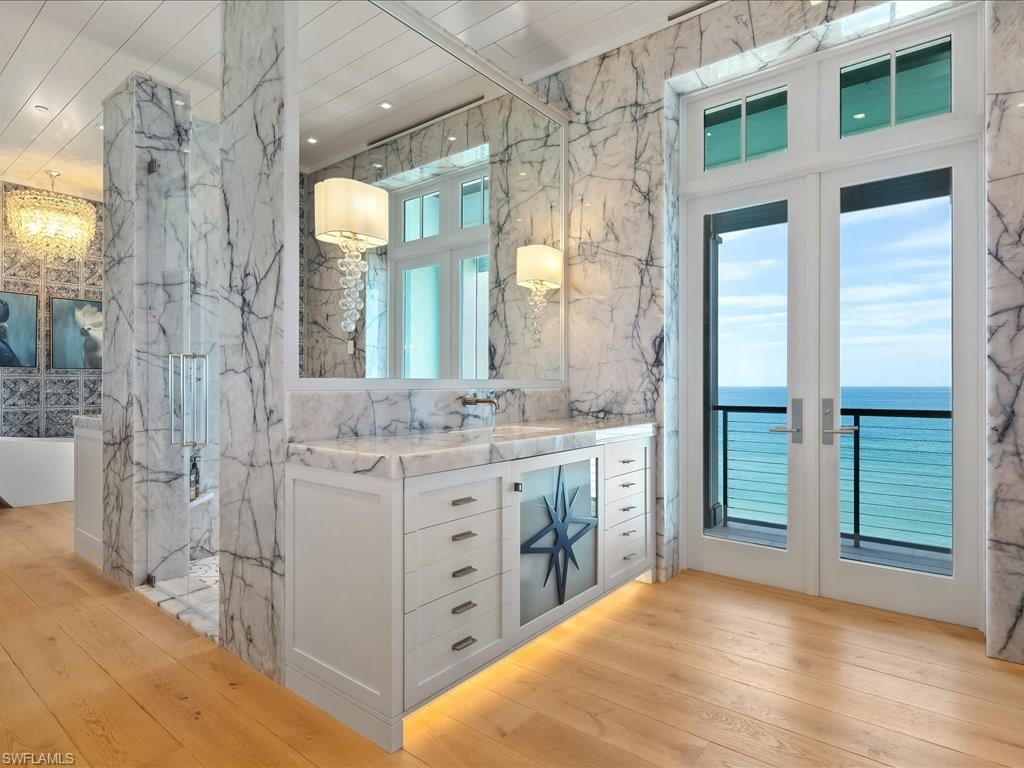 7409 Bay Colony Drive Naples, FL 34108 - Photo 25 of 48 a bathroom with a double vanity sink toilet and shower