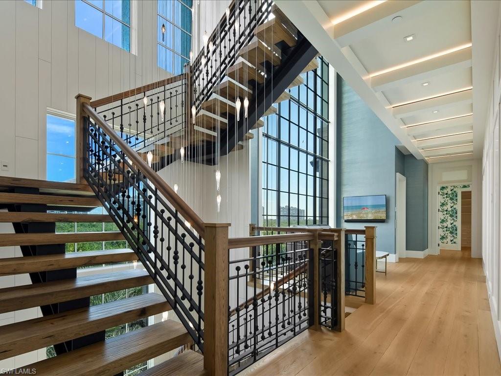 7409 Bay Colony Drive Naples, FL 34108 - Photo 33 of 48 a view of entryway and hall with wooden floor