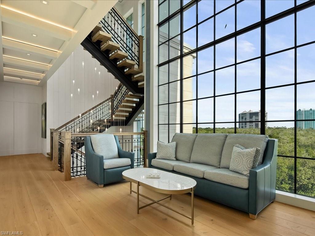 7409 Bay Colony Drive Naples, FL 34108 - Photo 34 of 48 a living room with furniture and a painting on the wall