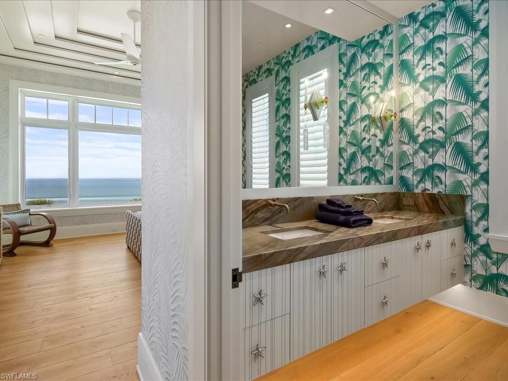 7409 Bay Colony Drive Naples, FL 34108 - Photo 38 of 48 a bathroom with a sink and a window