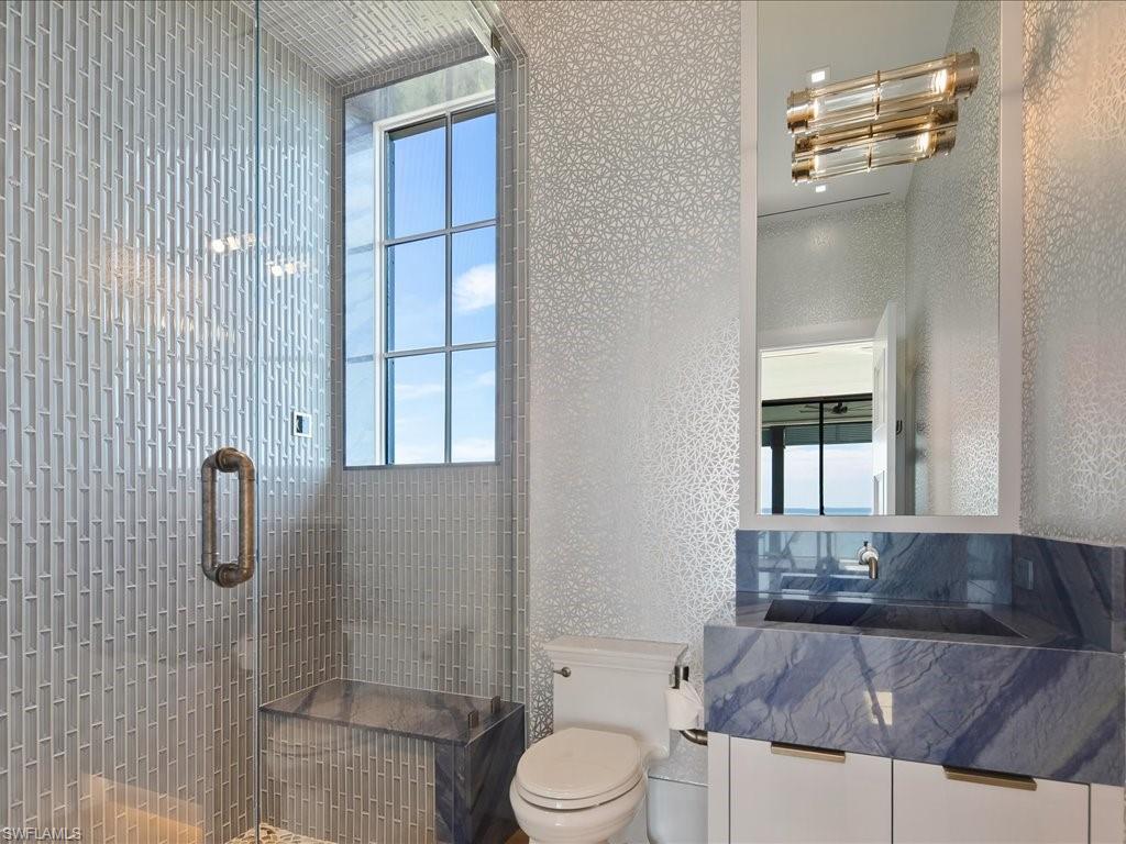 7409 Bay Colony Drive Naples, FL 34108 - Photo 42 of 48 a bathroom with a granite countertop sink toilet and shower