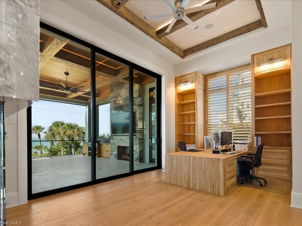 7409 Bay Colony Drive Naples, FL 34108 - Photo 10 of 48 a room with furniture and large windows