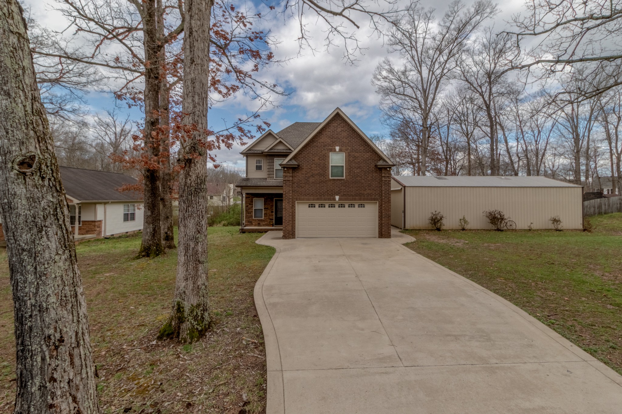 280 Harper Road Clarksville, TN 37043 - Photo 2 of 23 a front view of a house with a yard and large tree