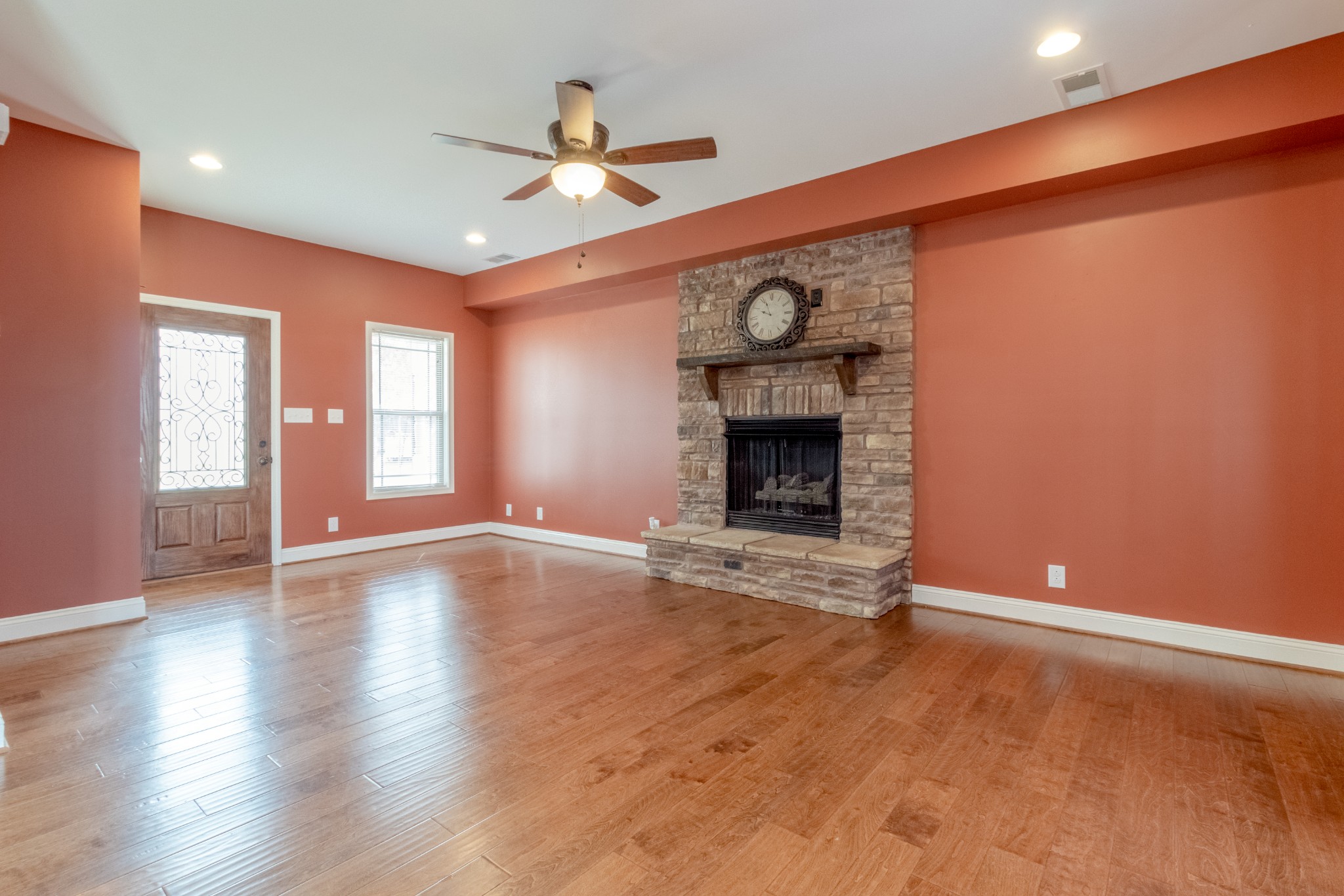 280 Harper Road Clarksville, TN 37043 - Photo 6 of 23 an empty room with wooden floor fan and windows